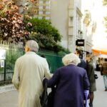 Coppia di anziani che passeggia a braccetto in città